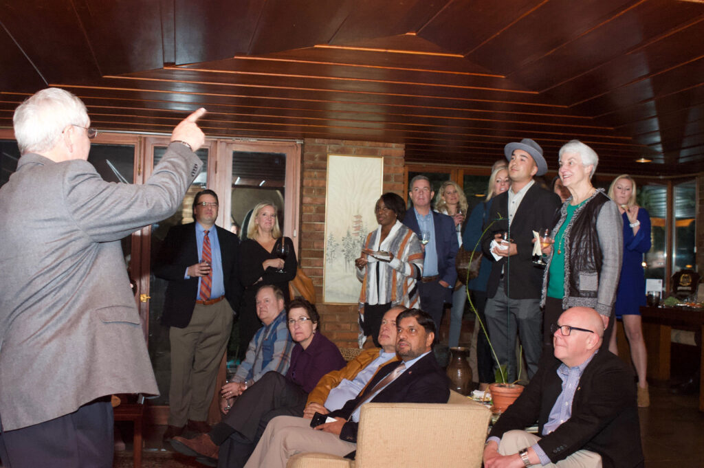 Foundation President/CEO Doug Tystad, left, conducts an impromptu history lesson for attendees at the fundraiser conducted Oct. 25 at the Frank Lloyd Wright home of Jim Blair in Kansas City.